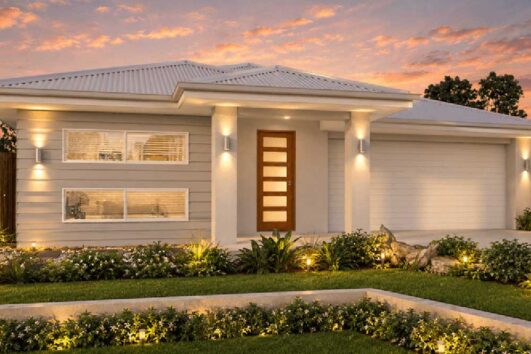 Modern single-story home with a wooden front door, warm entrance lighting, and a manicured front garden at sunset.