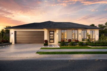 Modern single-story home with a two-car garage and a manicured front yard at sunset.