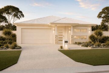 Modern single-story house with a two-car garage, beige exterior, and desert landscaping in the front yard.